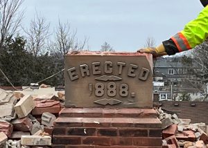 The above photo shows the corner stone being gently removed on November 29 2022 during the demolition of the Church.